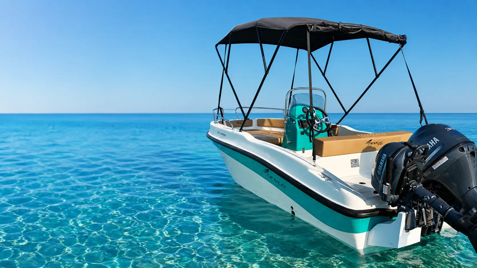 Riptide boat angled across clear water near Afandou Beach