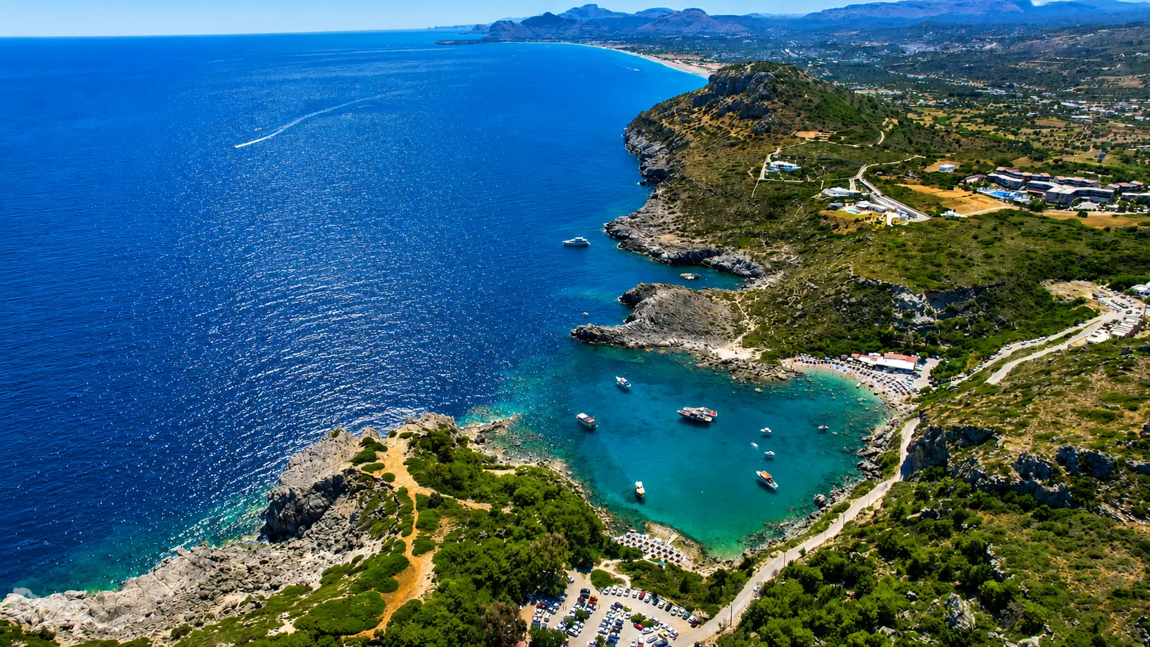 Aerial view of Ladiko Bay cove with calm turquoise water